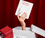 Holiday Gift Set 2023 holded by a hand out of a gift Juliette has a gun